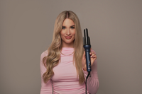 Woman holding a G&C Gold Class Auto Curler – Automatic Hair Curler for Perfect Curls