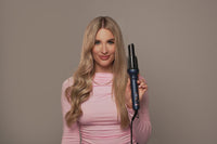 Woman holding a G&C Gold Class Auto Curler – Automatic Hair Curler for Perfect Curls