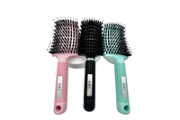Three gold class g&c hairbrushes with different handles on a white background
