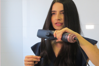 Woman using a hair straightener dryer g&c gold class